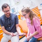 Zahnarzt Dr. Mark Stephan Lindner berät eine junge Patientin